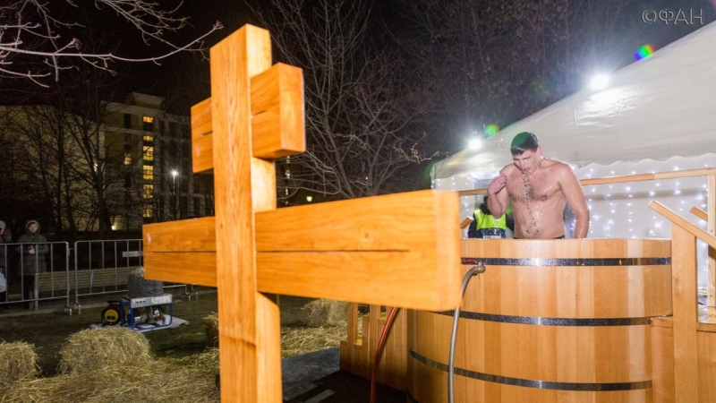 Russian believers plunged into the hole, to celebrate the Orthodox Baptism