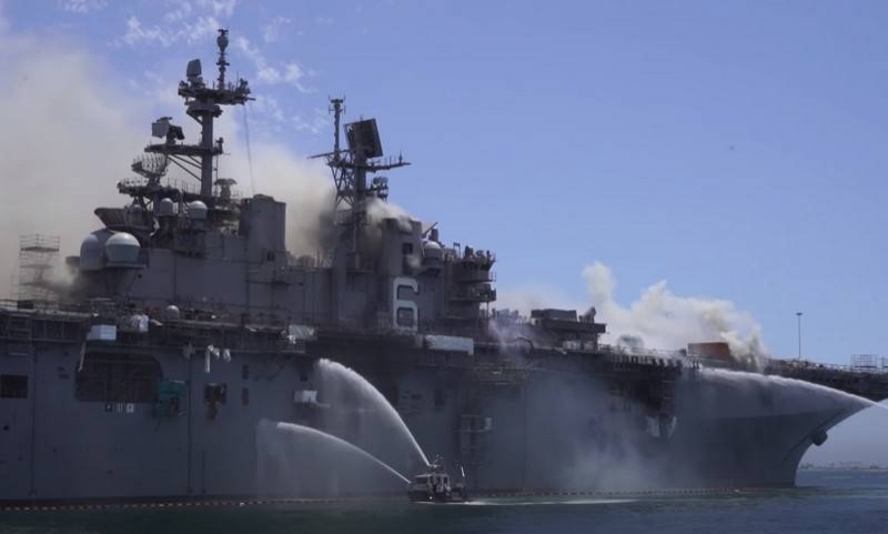 Part of the take-off deck collapses on the burning American UDK Bonhomme Richard