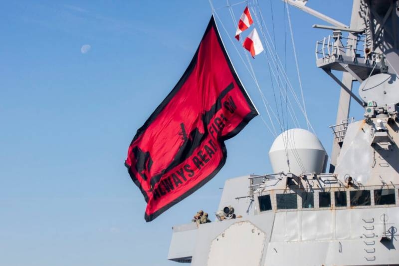 American media are interested in the new red and black flag, flying over a US Navy destroyer